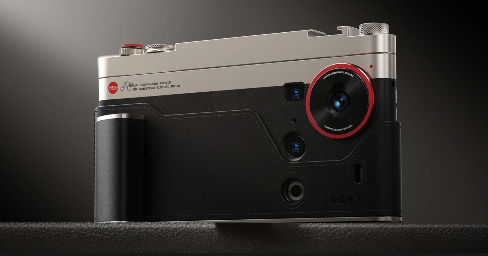 A close-up of a modern camera with a metallic top, black leather texture, and a prominent lens outlined in red. The camera has several buttons, dials, and is resting on a dark surface. A close-up of a modern camera with a metallic top, black leather texture, and a prominent lens outlined in red. The camera has several buttons, dials, and is resting on a dark surface.