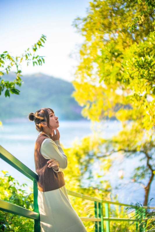 A portrait of a woman looking up at a tree A portrait of a woman looking up at a tree