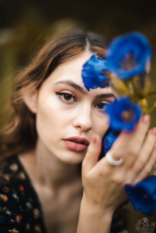 A portrait of a woman posing with a flower A portrait of a woman posing with a flower