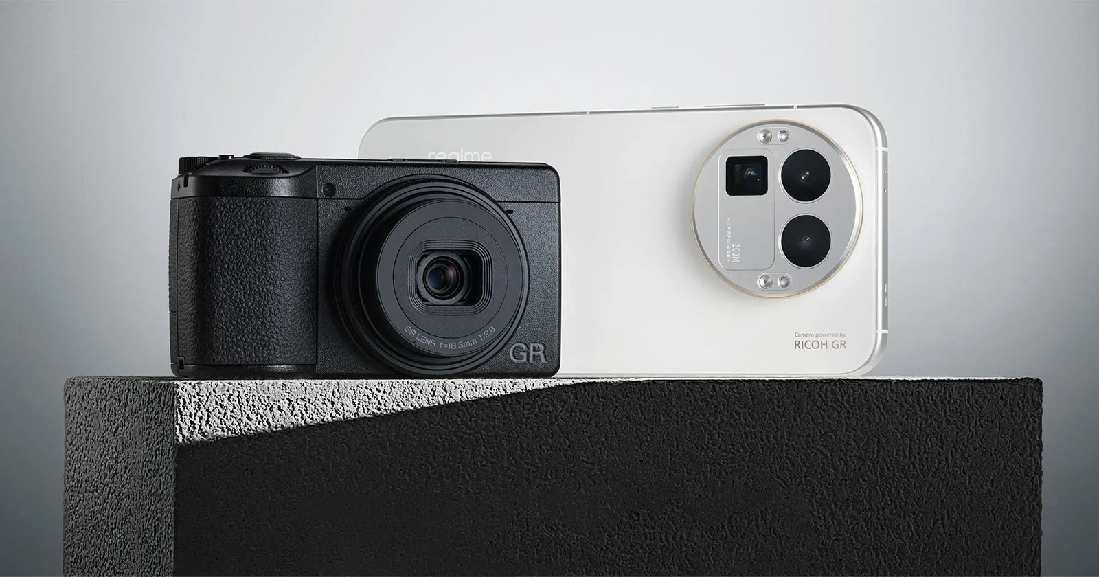 A black compact camera and a white smartphone with triple rear cameras are displayed side by side on a textured gray surface against a minimalist background. A black compact camera and a white smartphone with triple rear cameras are displayed side by side on a textured gray surface against a minimalist background.