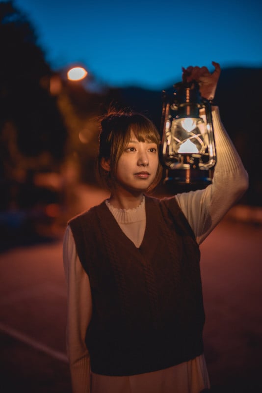 A portrait of a woman holding a lantern at night A portrait of a woman holding a lantern at night