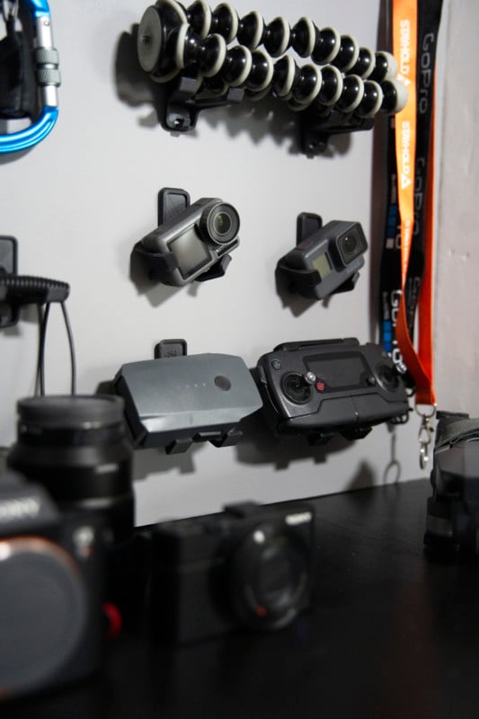 Action camera, drone parts, and tripod hung on a wall Action camera, drone parts, and tripod hung on a wall
