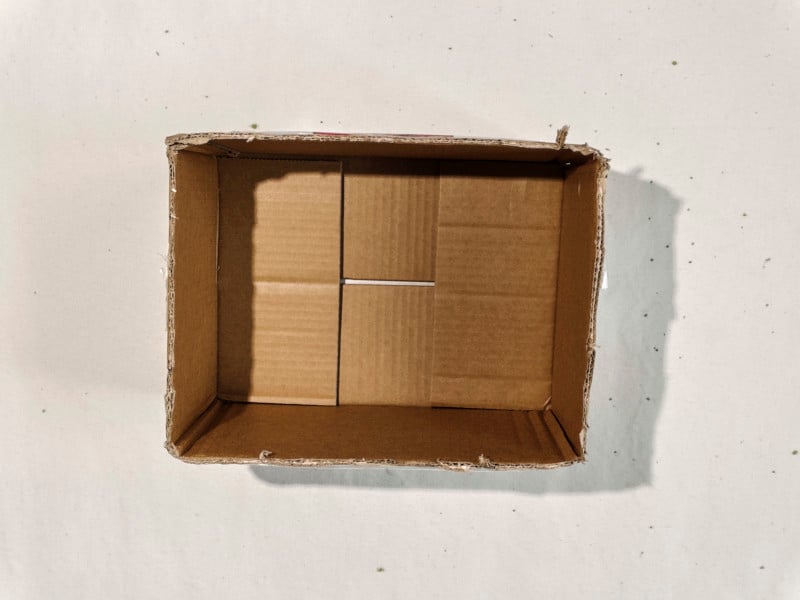 A cardboard box with its lid flaps cut off A cardboard box with its lid flaps cut off