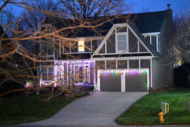 A photo of a house at night lit with Christmas lights A photo of a house at night lit with Christmas lights