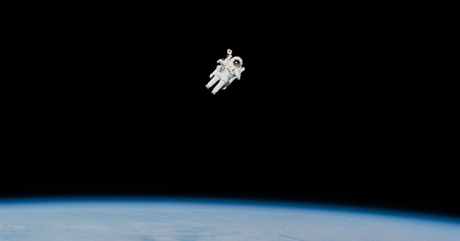 Astronaut Bruce McCandless II approaches his maximum distance from the Earth-orbiting Space Shuttle Challenger in this 70mm photo from Feb. 7, 198