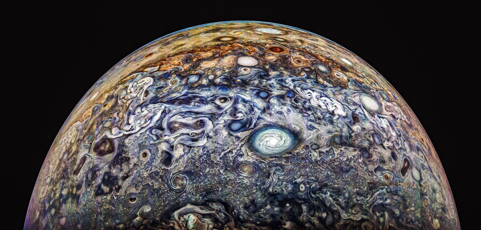 Colorful and swirling cloud patterns on Jupiter's atmosphere are shown, featuring a prominent white circular storm in the center, with various shades of blue, brown, and orange throughout the gaseous landscape under a dark sky. Colorful and swirling cloud patterns on Jupiter's atmosphere are shown, featuring a prominent white circular storm in the center, with various shades of blue, brown, and orange throughout the gaseous landscape under a dark sky.