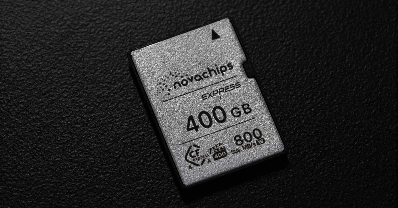 A close-up of a 400 GB Novachips Express memory card with 800 MB/s speed, resting on a textured black surface. A close-up of a 400 GB Novachips Express memory card with 800 MB/s speed, resting on a textured black surface.