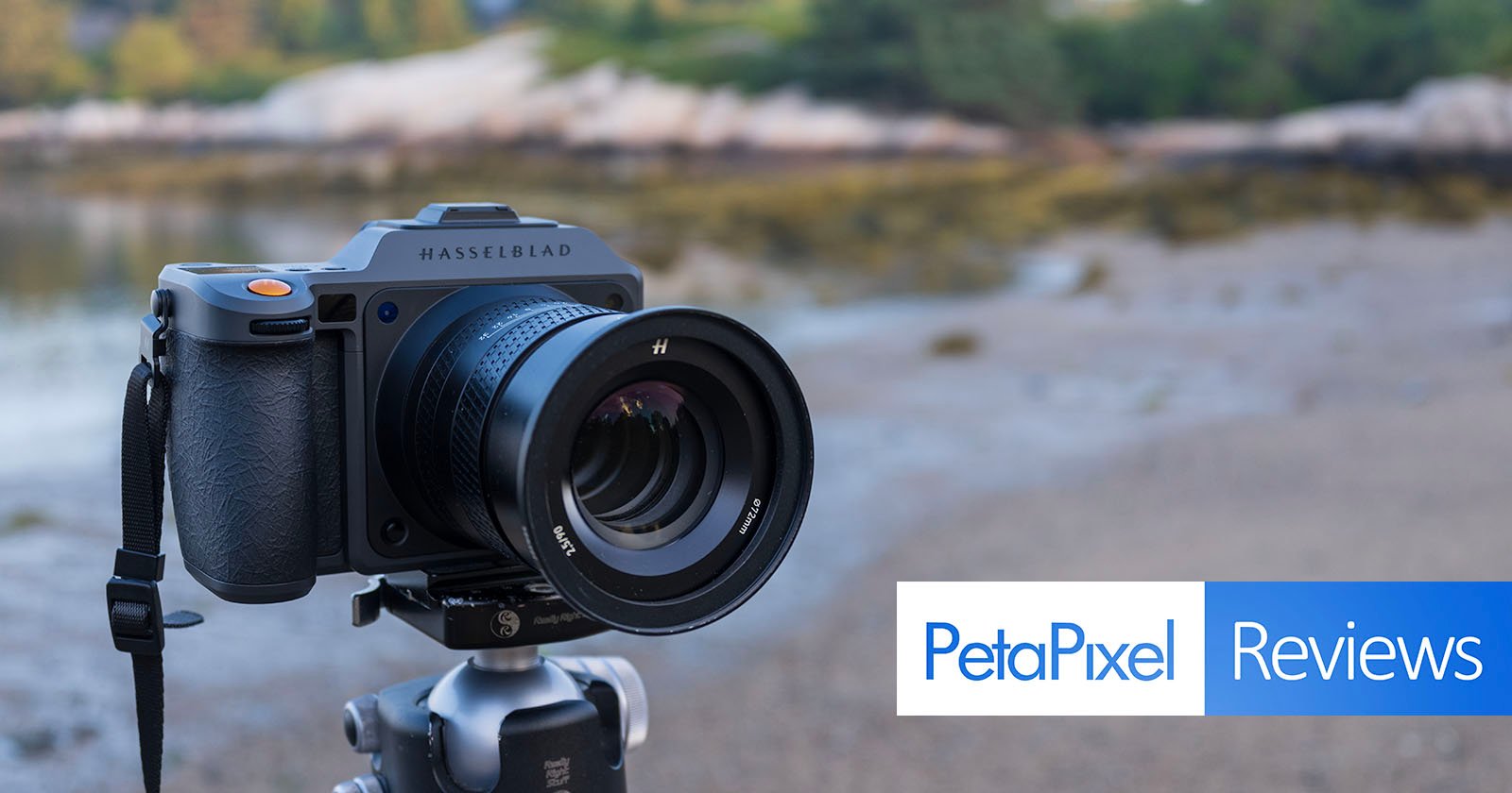 A Hasselblad camera mounted on a tripod outdoors, with a blurred natural background. The image features the Petapixel Reviews logo in the bottom right corner. A Hasselblad camera mounted on a tripod outdoors, with a blurred natural background. The image features the Petapixel Reviews logo in the bottom right corner.