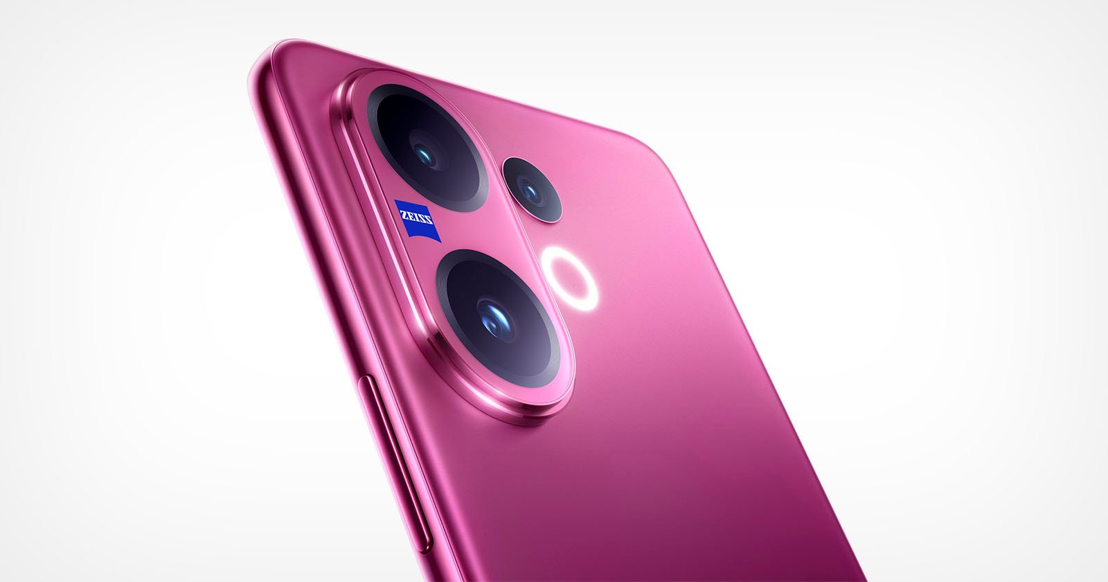 Close-up of a pink smartphone’s rear camera module featuring three lenses and a small Zeiss logo, against a plain white background. Close-up of a pink smartphone’s rear camera module featuring three lenses and a small Zeiss logo, against a plain white background.