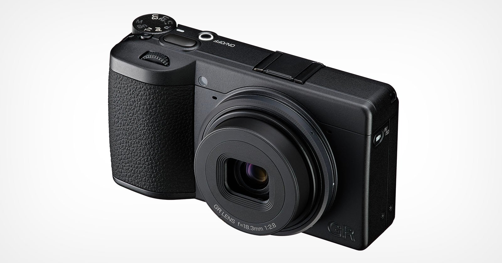 A black compact digital camera with a textured grip, labeled GR on the front, featuring a prominent lens and control dials on top, photographed against a plain white background. A black compact digital camera with a textured grip, labeled GR on the front, featuring a prominent lens and control dials on top, photographed against a plain white background.